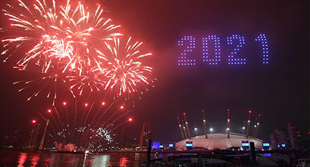 Fireworks and drones illuminate the night sky over the The O2 arena in London