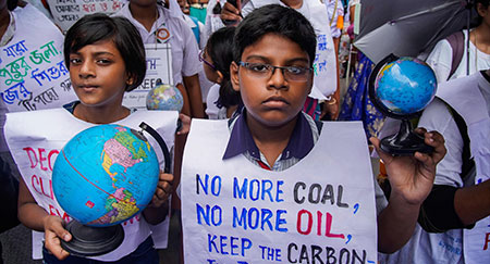 Students and adults take part in a climate strike rally in Kolkata to protest against government inaction on climate change.