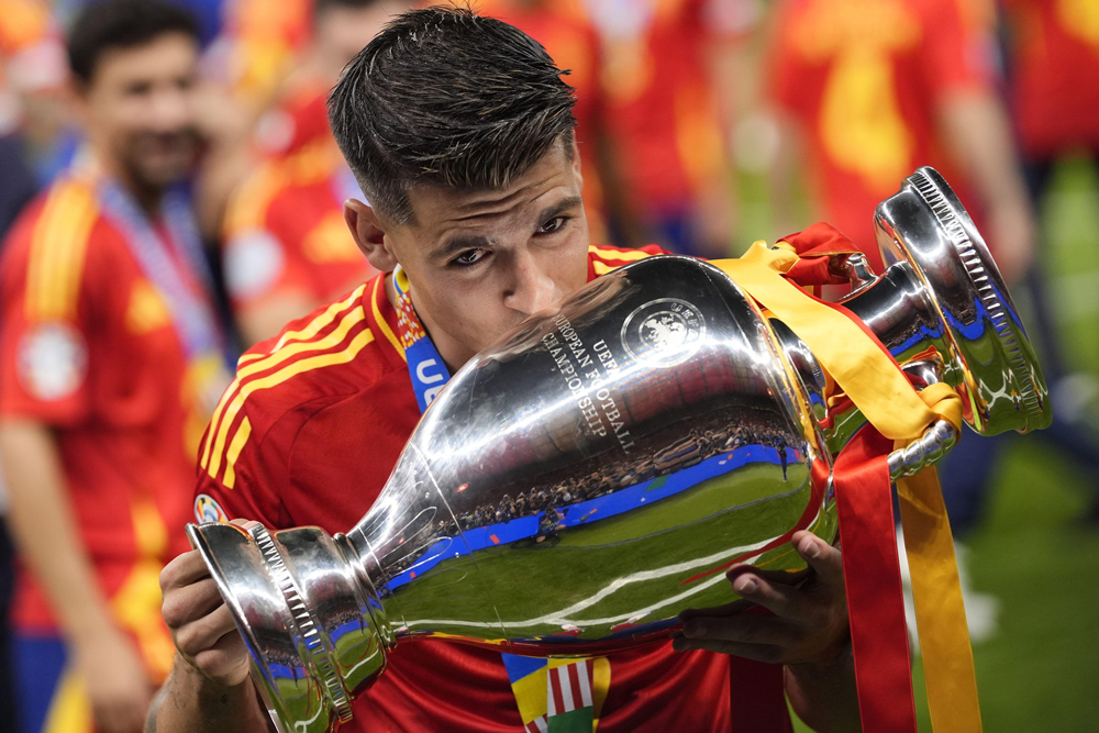 Spain's Alvaro Morata with the trophy celebrates after a final match between Spain and England at the Euro 2024 soccer tournament in Berlin at Olympiastadium, Germany, Sunday, July 14, 2024