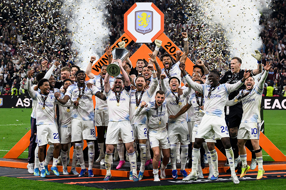 John McGinn of Aston Villa FC lifts the trophy as teammates celebrate during the UEFA Europa League 2025/26 final 
