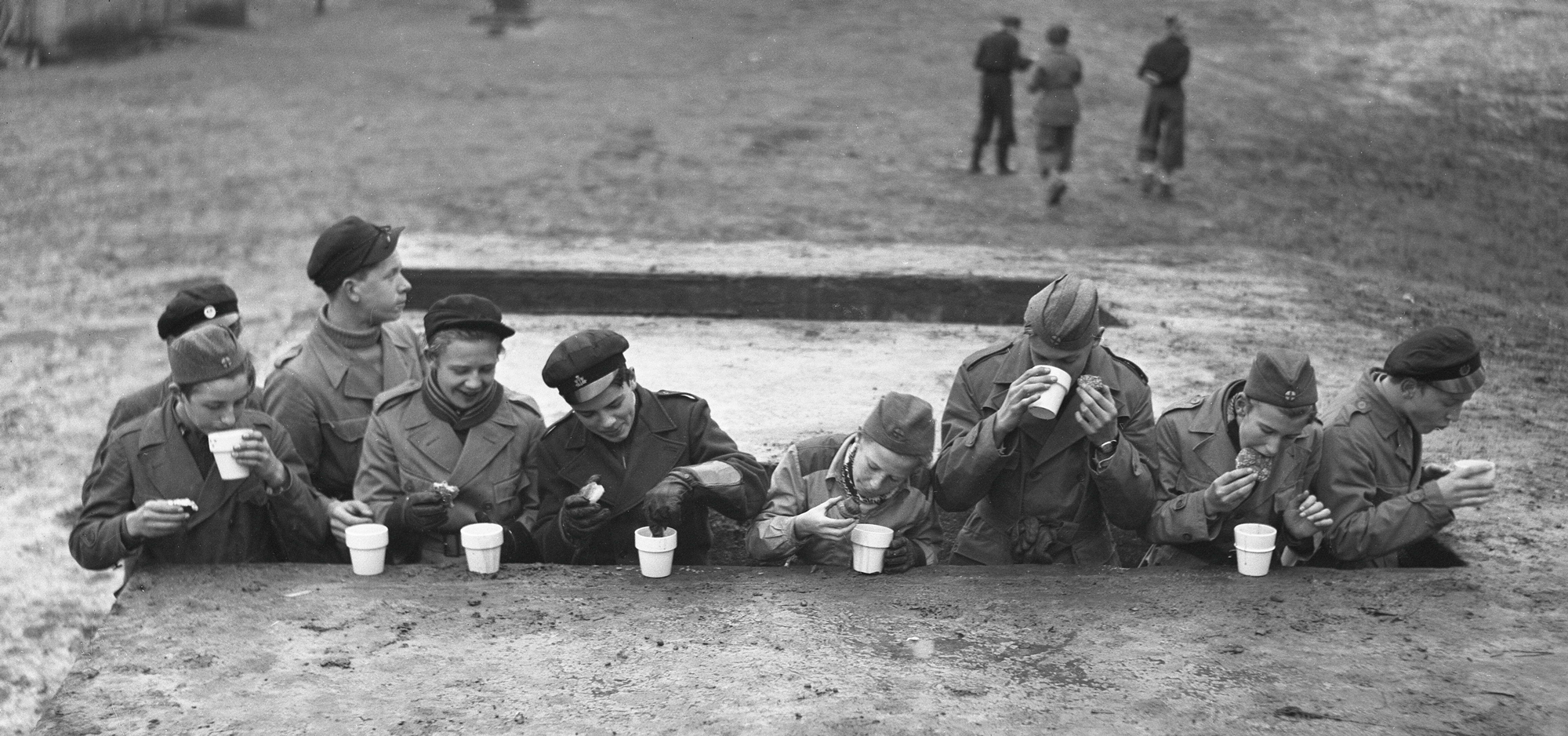 Teenagers from a military volunteer organization take a break from training and drink hot chocolate and eat buns, Sweden, November 1939