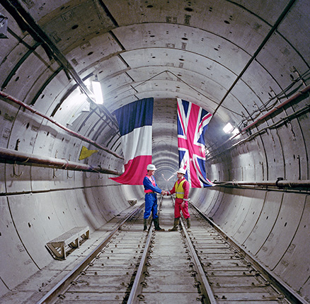 In a Channel Tunnel rail tunnel, a French and UK engineer commemorate the first linking of the two countries since the Ice Age. 