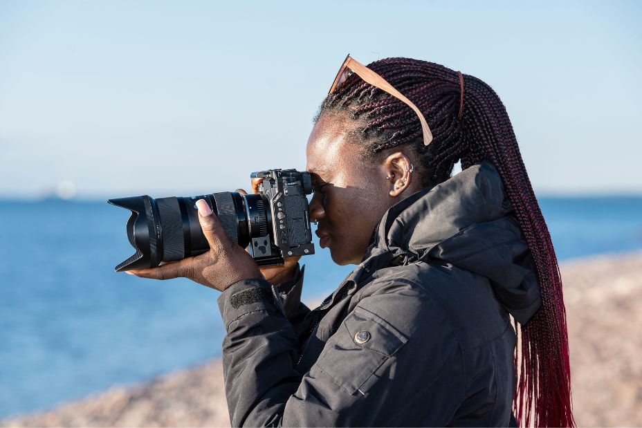 African hobbyist photographer out in nature and taking pictures with a mirrorless camera