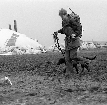 A member of the mountain rescue team helping in the search around Lockerbie, passes the remains of the cockpit of the Pan Am Boeing 747, which crashed, killing all 258 on board and 17 people on the ground.