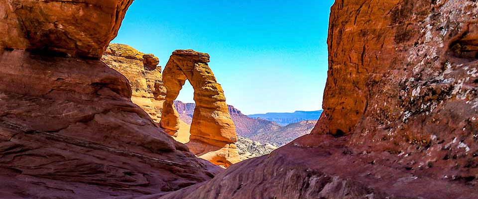 The Arches National Park, Moab Utah. A view from one of the smaller arches shows the Delicate Arch in the background. Resembles a Cat's Eye 