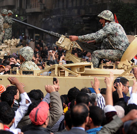 gyptian demonstrators near a military tank during protests in Cairo's Tahrir square at the biggest anti-government protests in three decades in a bid to topple the government President Hosni Mubarak in Cairo, Egypt on January 29, 2011.
