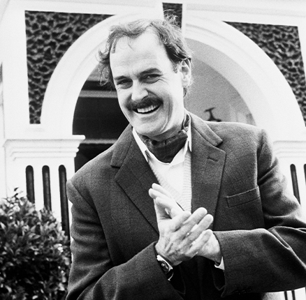 Comedian John Cleese in his role as Basil Fawlty, the manic host of Fawlty Towers