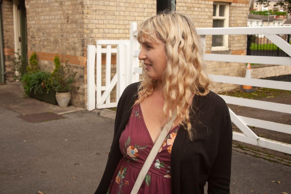 Awaiting Adventure: A young woman with a captivating smile waits for the heritage train at the station, casting a candid glance into the distance - Image ID: 2T7WA88 (RF)