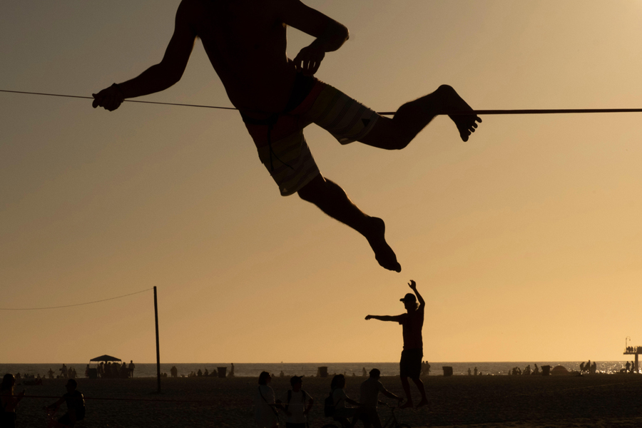 Balancing on a slackline, beach, Santa Monica, Los Angeles, California, USA