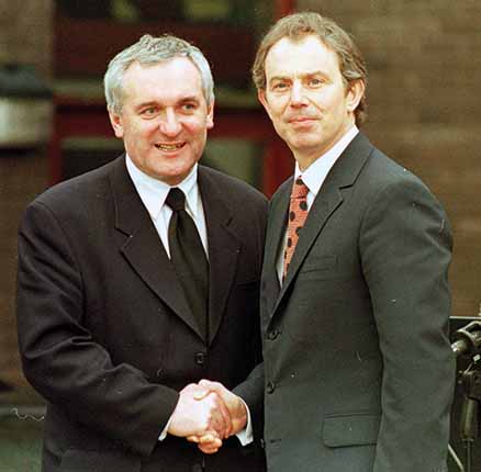 Tony Blair (right) and Bertie Ahern shake hands outside Stormont. 