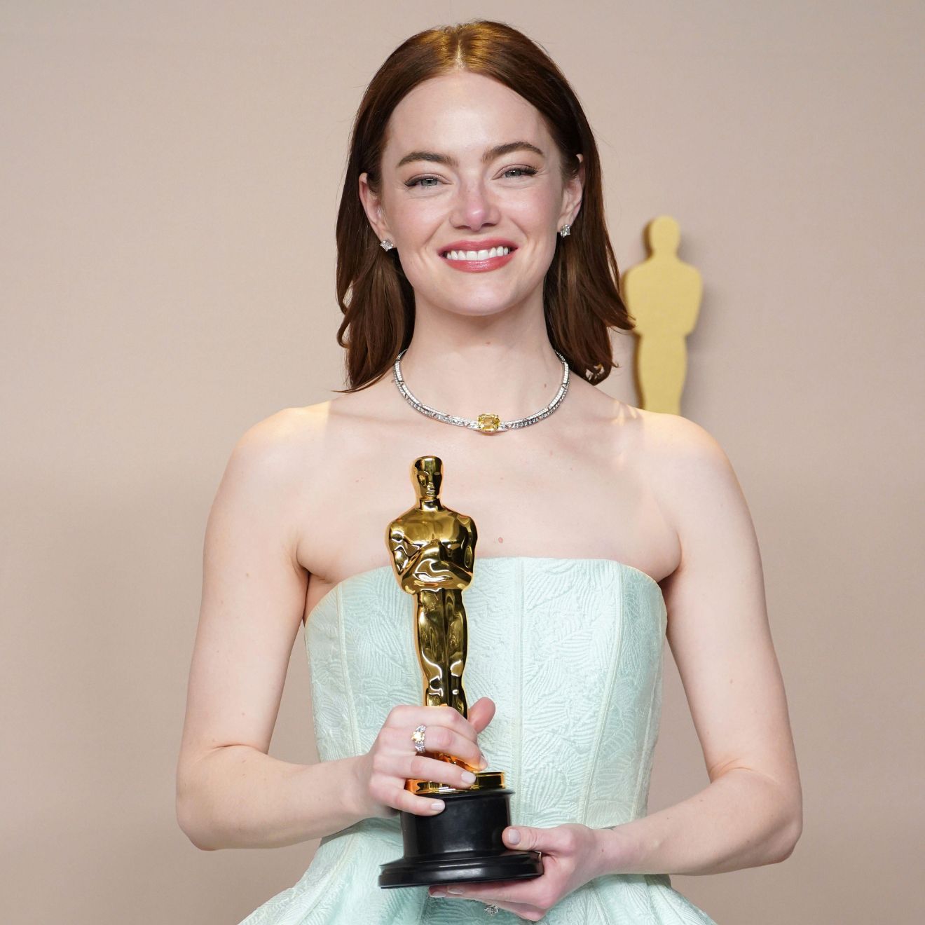 Emma Stone poses in the press room with the award for best performance by an actress in a leading role for "Poor Things" at the Oscars on Sunday, March 10, 2024, at the Dolby Theatre in Los Angeles.