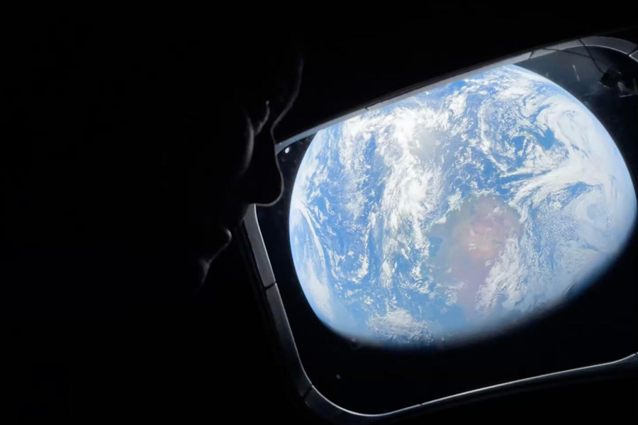 Commander Reid Wiseman looks at the Earth from a window aboard the Orion spacecraft Integrity during the Artemis II mission en route to the moon on Thursday, April 2, 2026