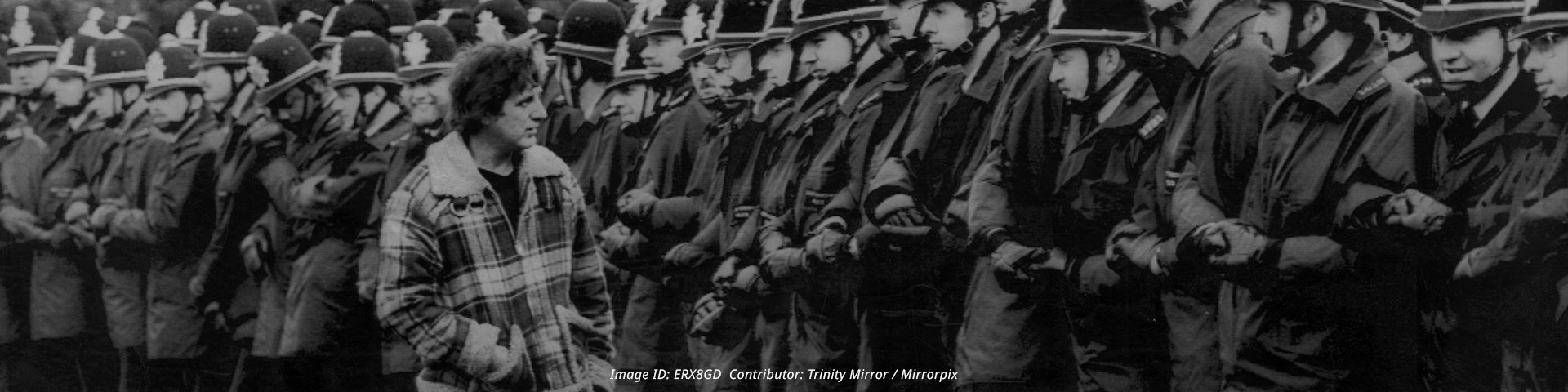 Miners Strike 1984 - 1985 Pictured. Miner Eric Hudson inspects the guard of police officers in the front line at Orgreave coking plant near Sheffield Yorkshire Monday 4th June 1984