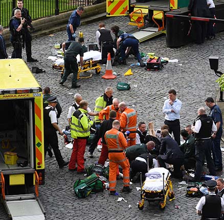 Emergency services at the scene outside the Palace of Westminster, London, after policeman has been stabbed and his apparent attacker shot by officers in a major security incident at the Houses of Parliament.