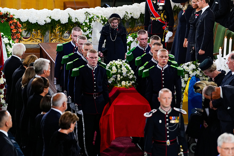 Queen Sonja walks behind the coffin with King Harald V as it is carried from the Royal Palace to Oslo Cathedral
