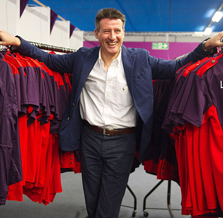 The Chair of the London Organising Committee of the Olympic and Paralympic Games, Sebastian Coe, poses for a photograph with some of the London 2012 Olympic Games Time uniforms