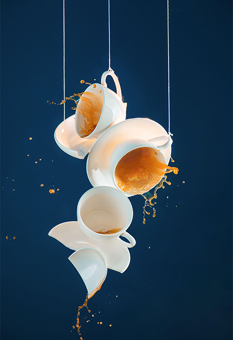 Coffee splashes, hanging porcelain cup sculpture, action food photography
