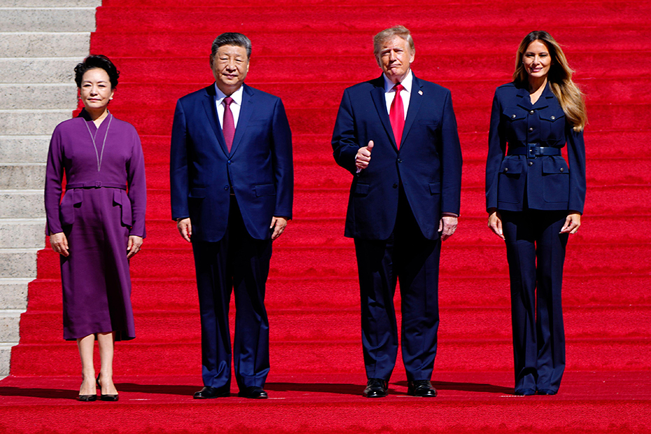 Chinese President Xi Jinping and his wife Peng Liyuan stand with President Donald Trump and First Lady Melania Trump as they arrive at the National Archives in Washington DC