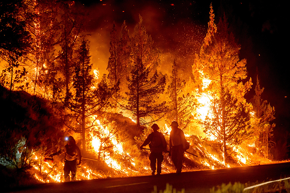 Firefighters burn off vegetation while trying to stop a wildfire called the Bench Fire from spreading in Warm Springs
