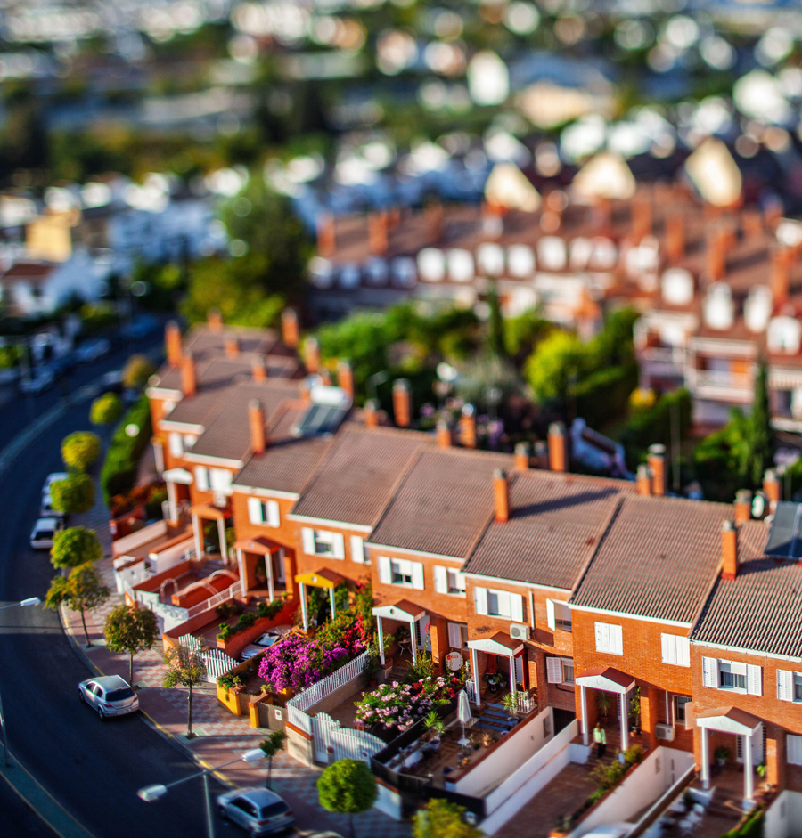 Tilt-shift perspective of residential homes highlighting architectural layout and community design