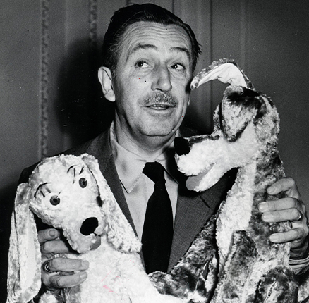 Walt Disney playing with stuffed animals