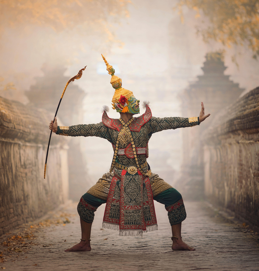 Traditional khon dancer performing outside a temple, Thailand