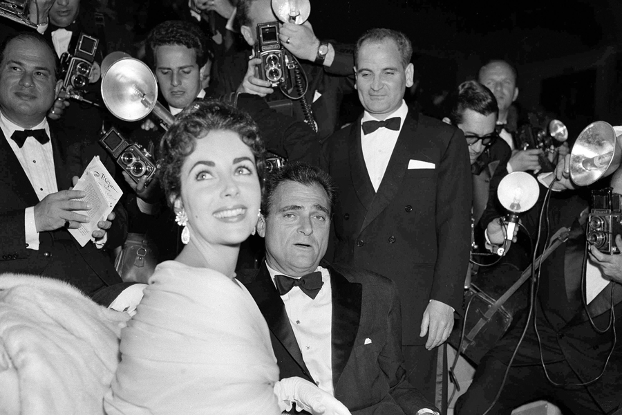 Elizabeth Taylor and her husband, producer Mike Todd are surrounded by photographers at the Cannes Film Festival at Cannes, France, May 2, 1955