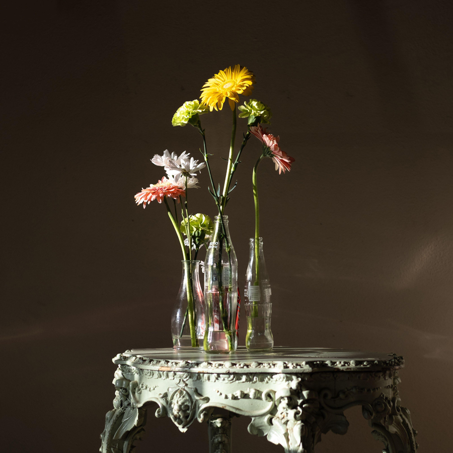 Vases with flowers on a small table