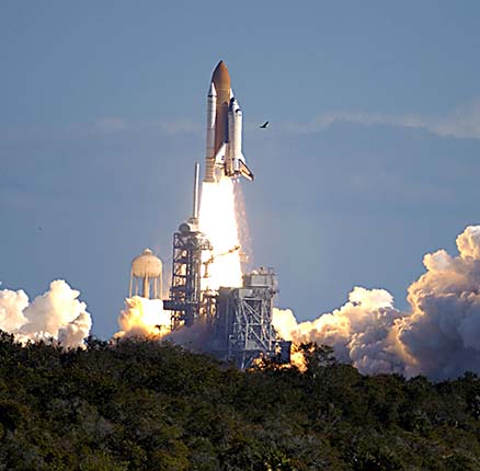 Through a cloud-washed blue sky above Launch Pad 39A, Space Shuttle Columbia hurtles toward space on mission STS-107. Following the countdown, liftoff occurred on-time at 10:39 EST.