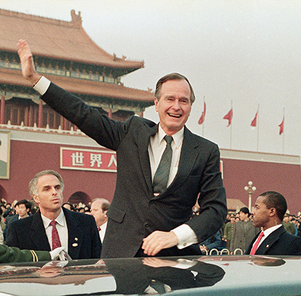 U.S. President George H.W. Bush stands on his car and waves to crowds in Tiananman Square in Beijing. Chinese state media are praising Bush as a "statesman of vision," recalling the late president's role in helping end the Cold War.