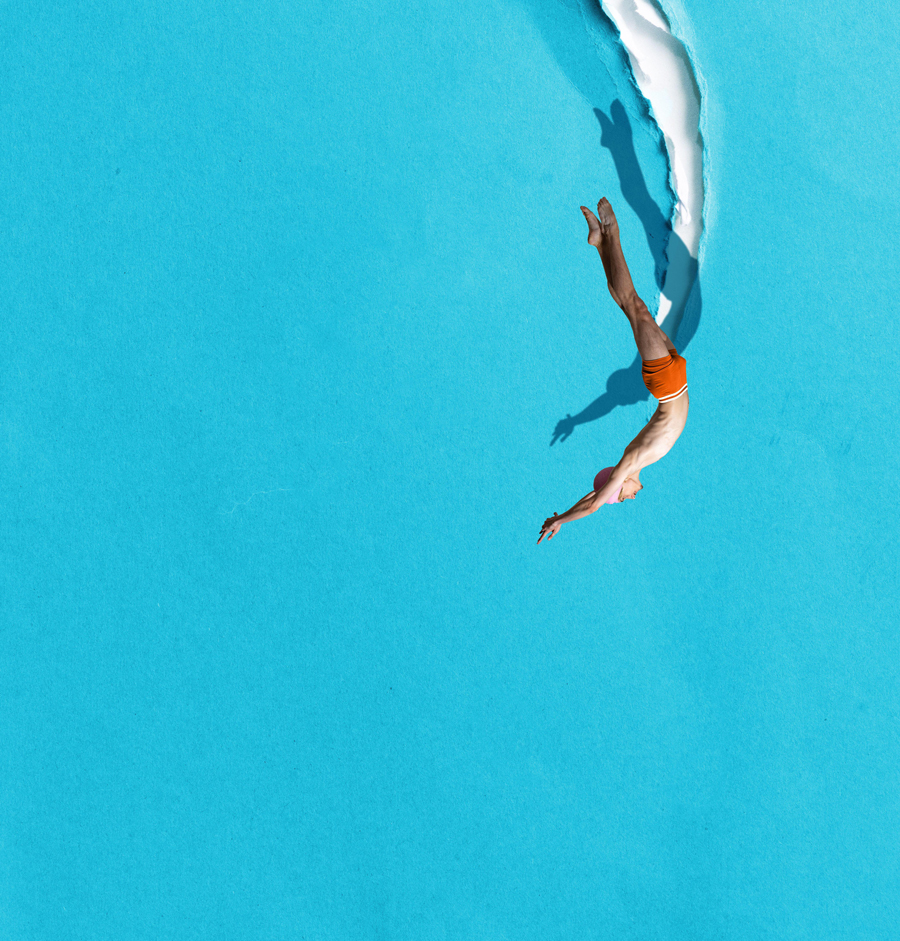 Minimalist pop art collage. Diver entering blue paper tear like breakthrough moment