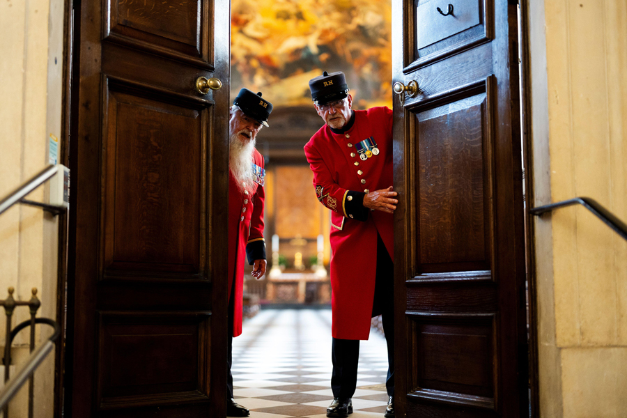 Chelsea Pensioners John (left), 76, and David, 75, lead a tour through the Wren Chapel at the Royal Hospital Chelsea in London