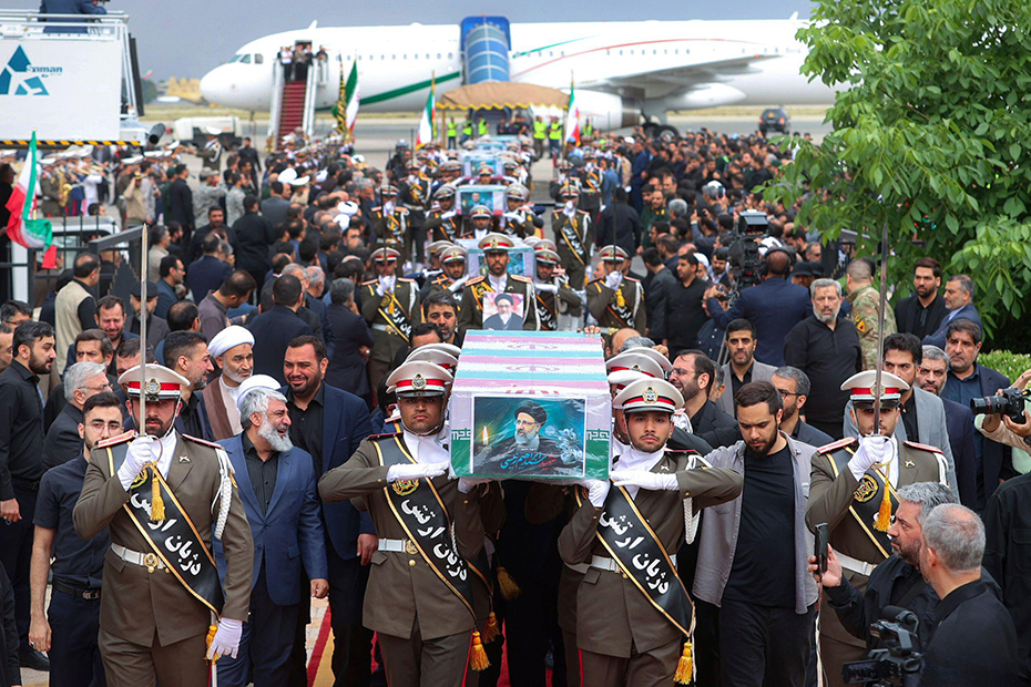 Army members carry the flag-draped coffins of President Ebrahim Raisi and his companions who were killed in a helicopter crash in a mountainous region of Iran.