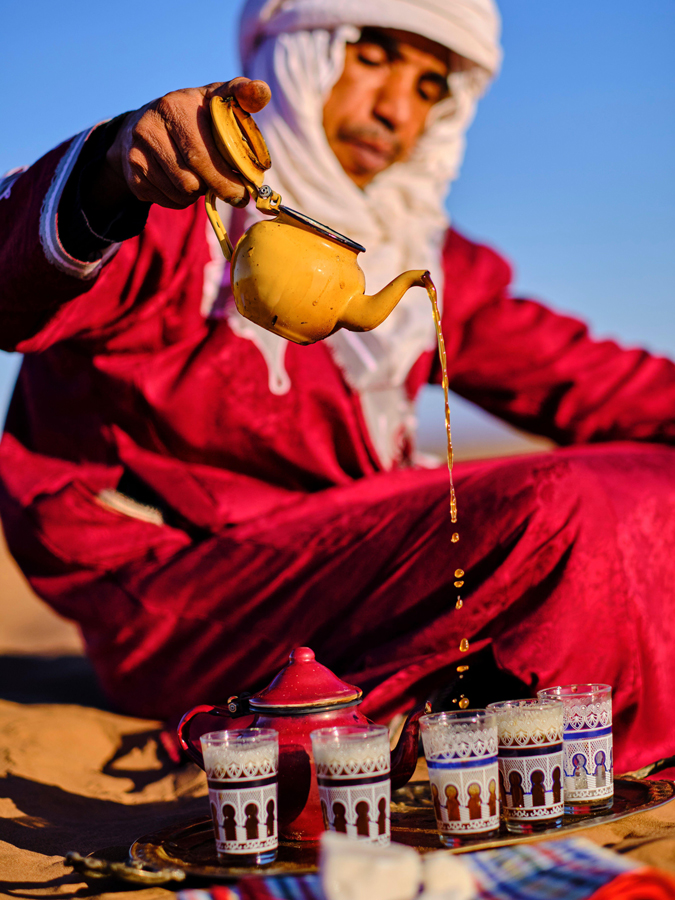 Man making tea in Merzouga desert, Tafilalet region, Morocco.