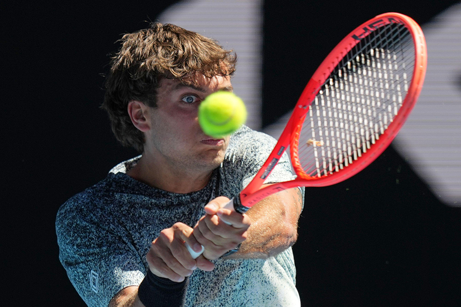 Flavio Cobolli of Italy plays a backhand return to Arthur Fery of Britain during their first round match at the Australian Open tennis championship in Melbourne, Australia