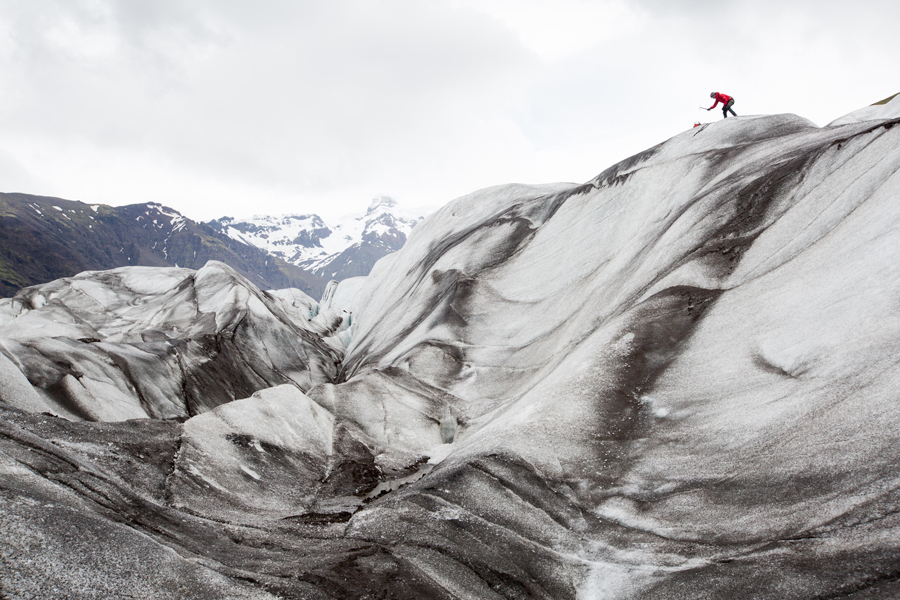 A climber uses an ice axe to climb Skaftafell Glacier, Iceland