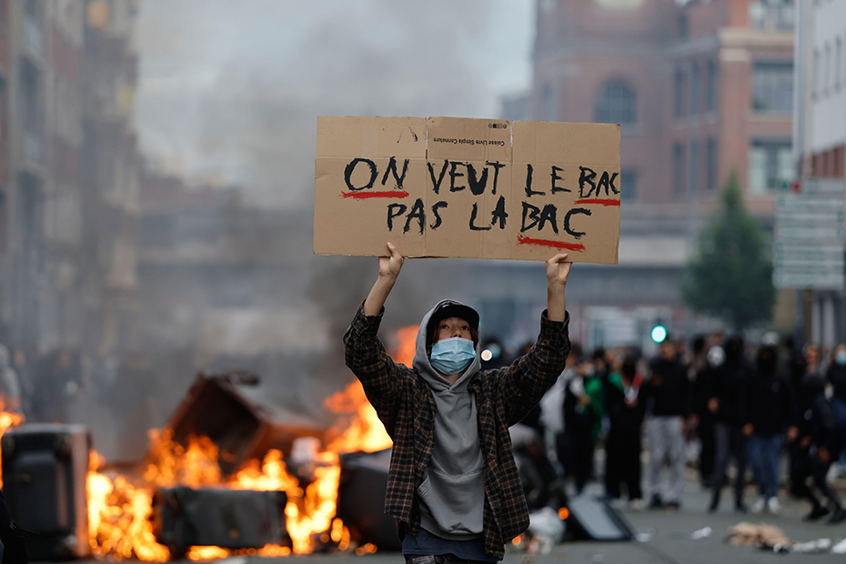A students holds a board during a protest to demand more resources at school, in Lille, France