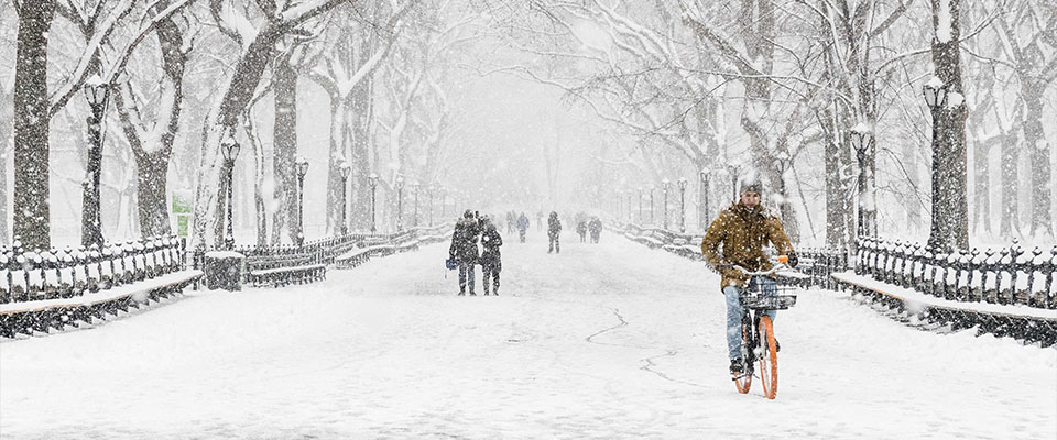 New York, NY, USA. 21st Mar, 2018. People walk and ride bikes, during a snow storm in the area of Bethesda Terrace in Central Park in New York City. 