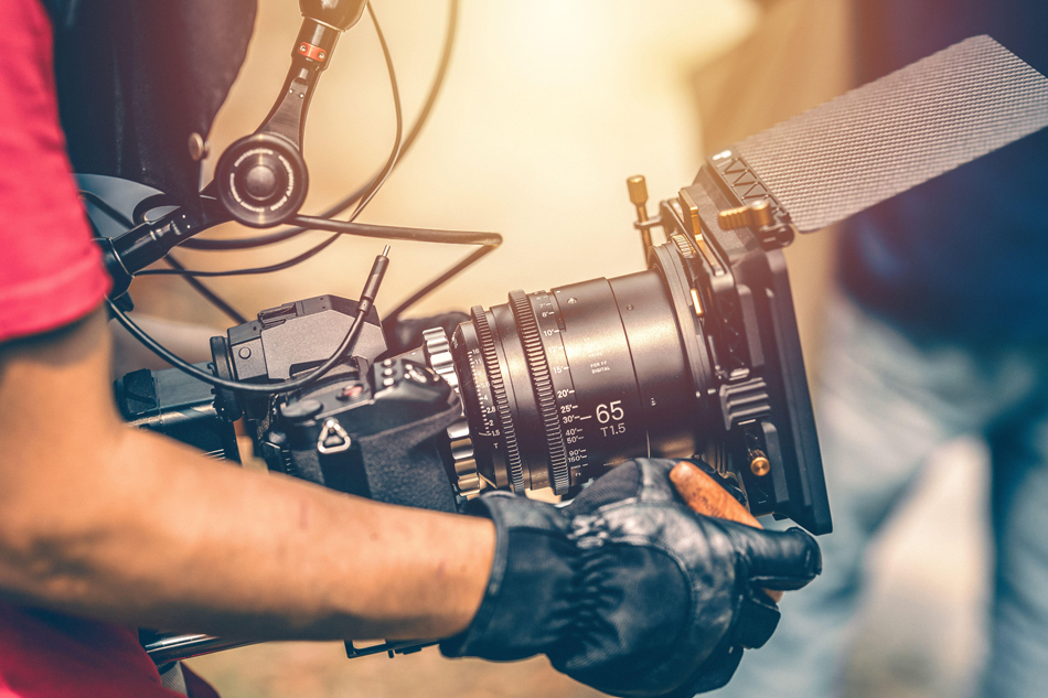 camera man behind the scenes shooting movie or video production