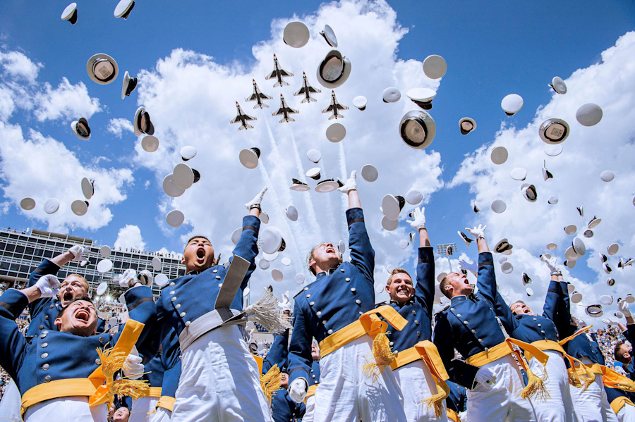United States Air Force Academy cadets toss their caps into the sky as the U.S Air Force Thunderbirds fly in formation overhead during graduation ceremonies at Falcon Stadium, May 30, 2024, in Colorado Springs, Colorado