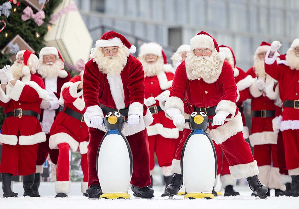 Father Christmas performers at Ministry of Fun's annual Santa School ice skate at London's only riverside ice rink, Glide at Battersea Power Station. Picture date: Tuesday November 14, 2023.
