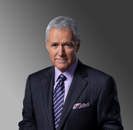 Alex Trebek host of jeopardy portrait, headshot with smiling somber pose, on grey background